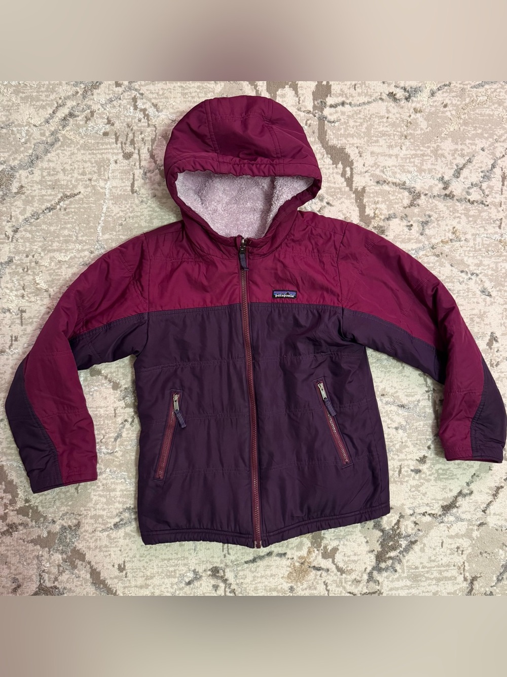 Patagonia Kids Two-Tone Plum and Berry Reversible Hooded Puffer Jacket.